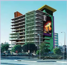 A rendering of a multistory structure with a billboard.