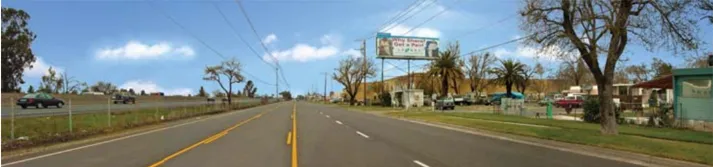 A photo of a street with a billboard.