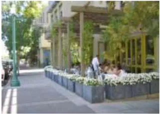 An image of patio seating along a sidewalk.