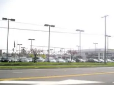 A photo of a parking lot from the road.