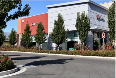 A photo of a shopping center building from the parking lot.