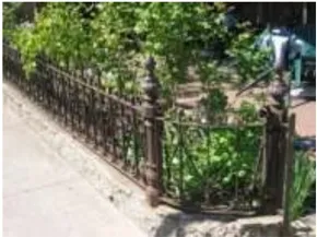A photo of a short wrought iron fence.