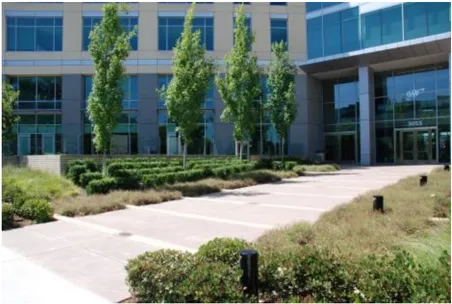 A photo of a building entrance with landscaping.