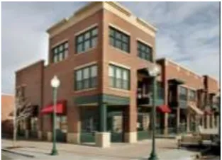 A photo of a three story brick building.