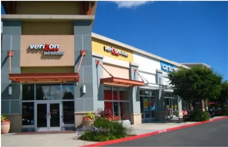 A photo of a shopping center with wall mounted signs.