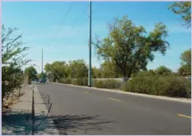 A photo of a road with an adjacent sidewalk.