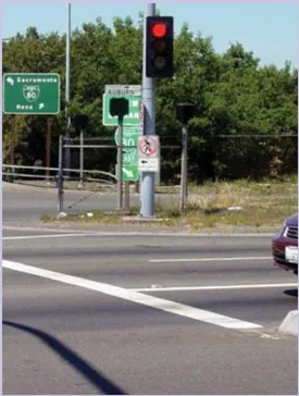 A photo of a red light and crosswalk.