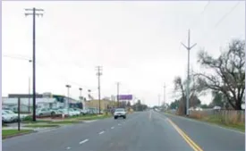 A photo of a street with power lines.