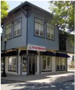 A photo of a two-story building on a street corner.