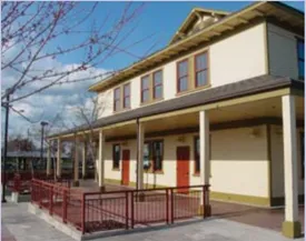 A photo of a building with red doors.