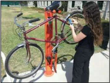 A photo of a person working on a bike.