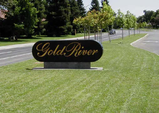 Community entrance monument sign within a wide grassy road median