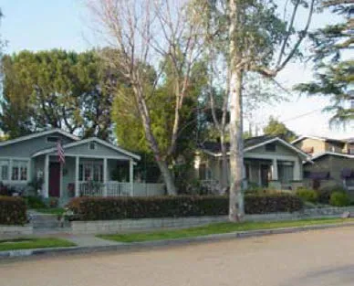 Two single-family detached houses with the same setback, compatible scale and mass.