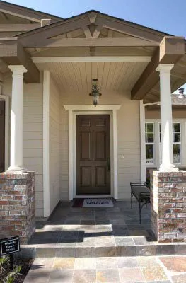 A lighting fixture hung above a recessed entry for a home.