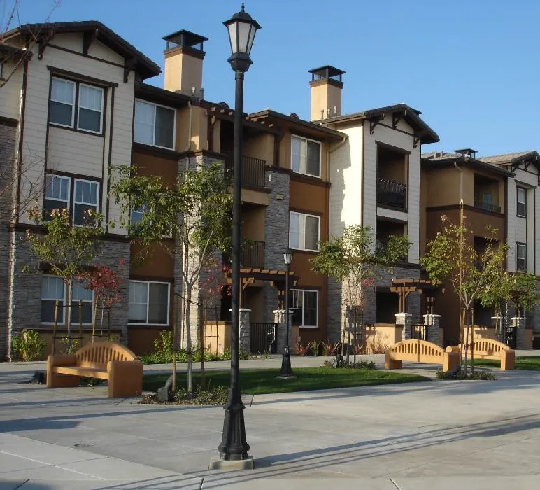 Multifamily building with offset wall planes using balconies