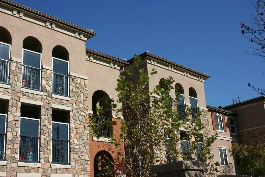 Multifamily building with offset wall planes and variety of complementary facade materials