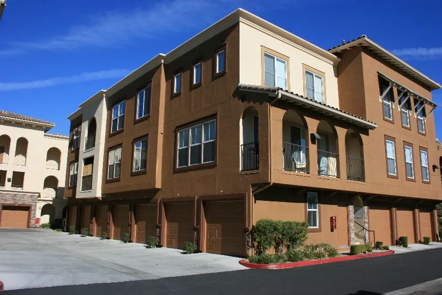 Multifamily building with garages and parking spaces located to the side of buildings