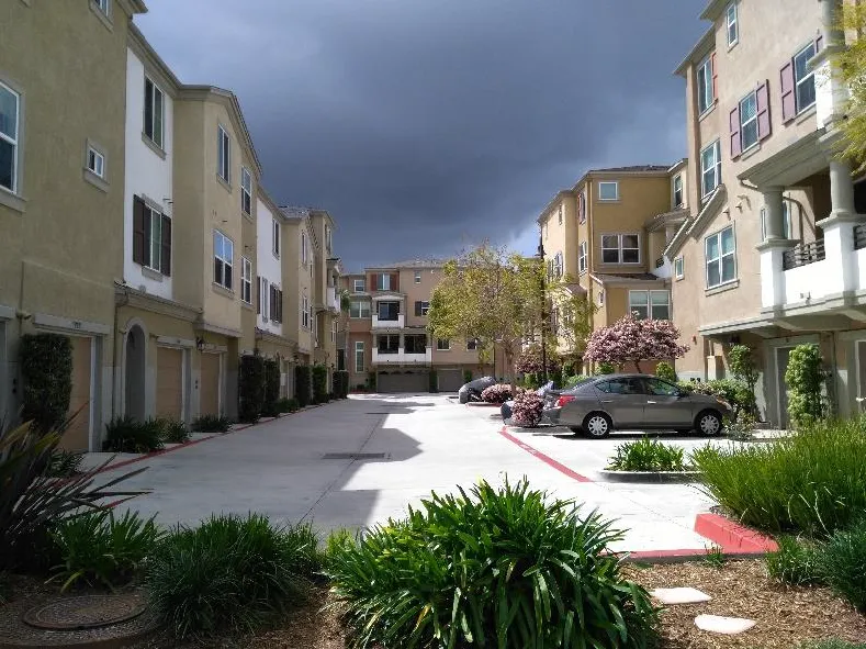 Multifamily building with garages and parking spaces located behind the buildings