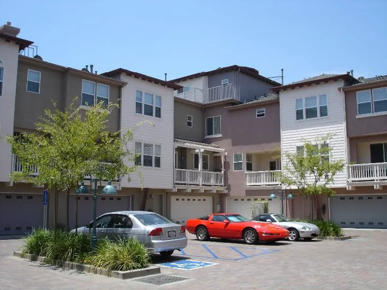 Townhomes with garages and parking spaces located behind the buildings