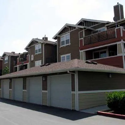 Multifamily building with garages matching main building design style