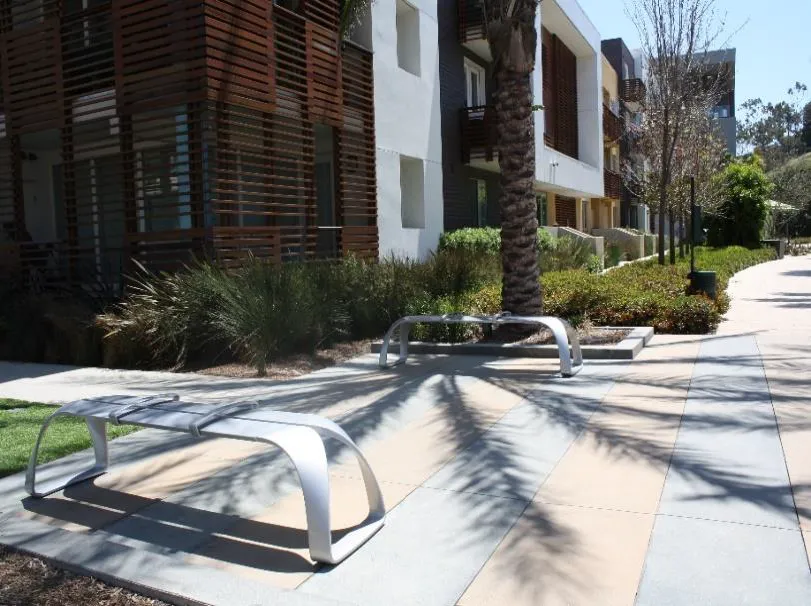 Pathways leading to benches next to townhomes