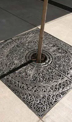 Square tree grate along sidewalk.