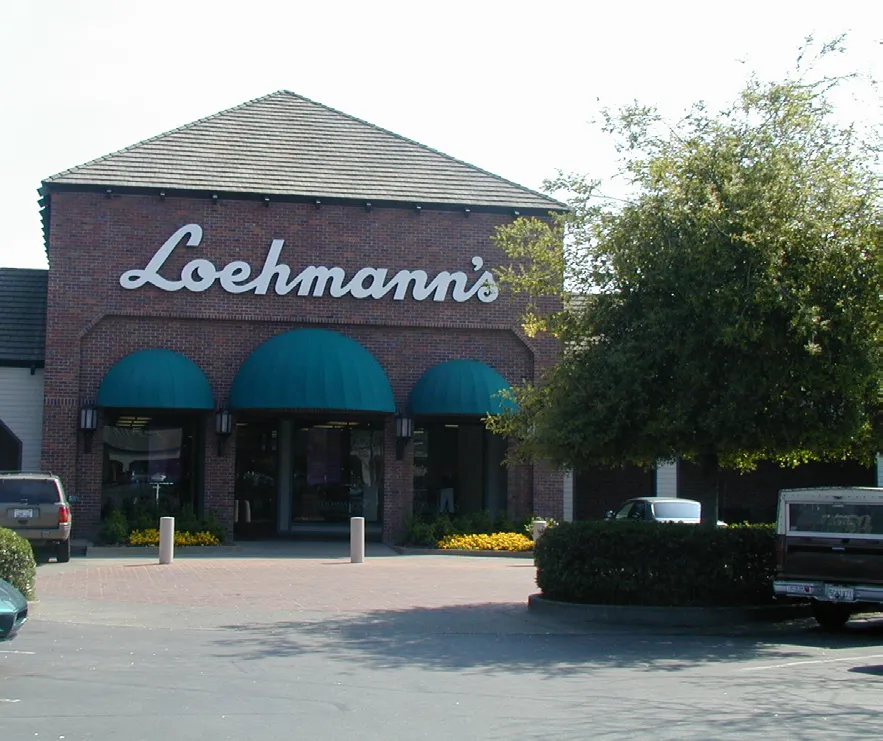 A retail project with storefronts containing street trees and architectural variety.