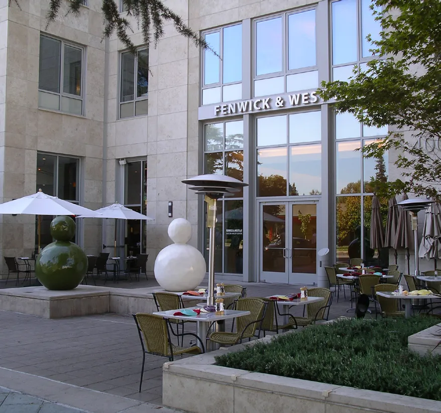 Outdoor seating area with two sculptures on display