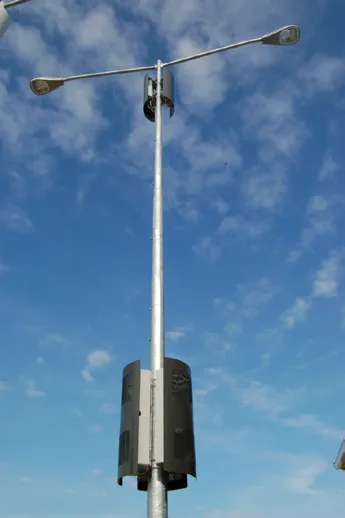 Wireless communication facility mounted on a street light pole