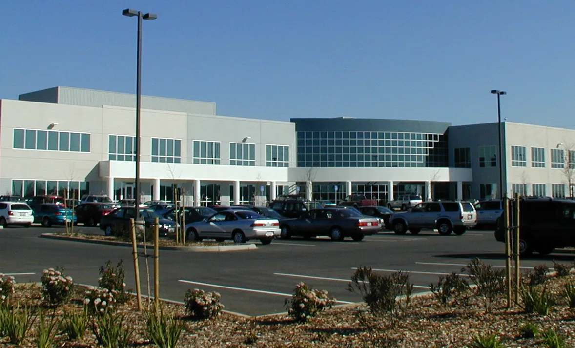 Street view of a office building and parking lot.