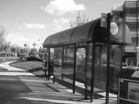 A bus stop adjacent to the office development entry.