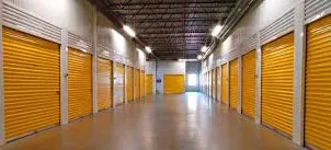 Inside an indoor self storage facility looking down a hallway with storage units on either side