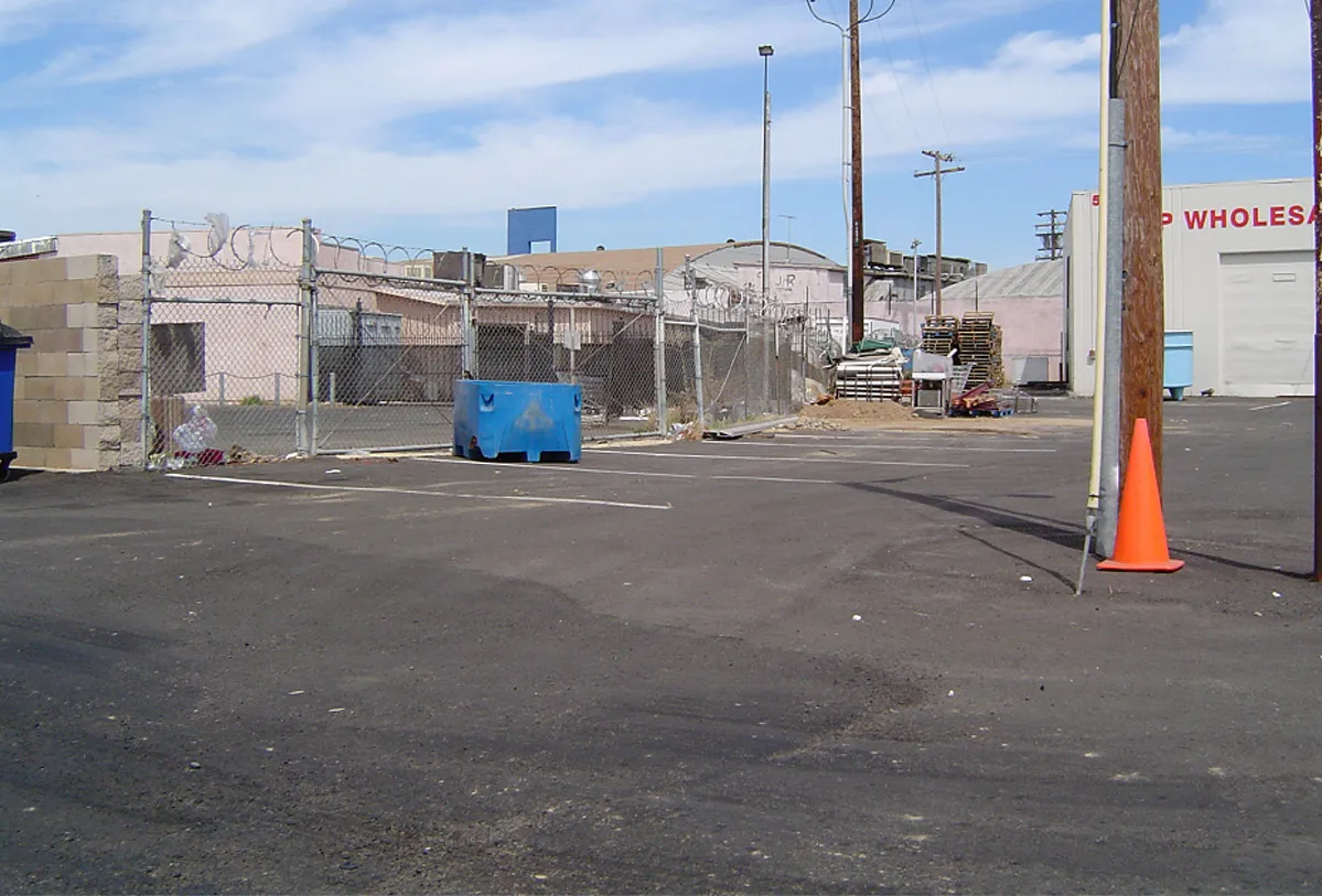 A barbwire fence with no landscaping, shown as the undesirable option.