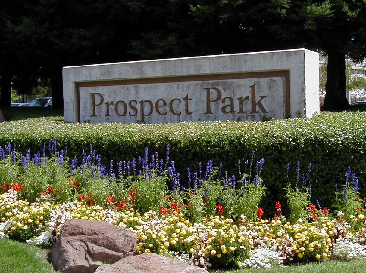 Monument sign of the "Prospect Park", with lots surrounding of landscaping.