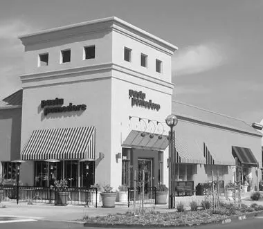 Storefront of commercial building on a corner lot.