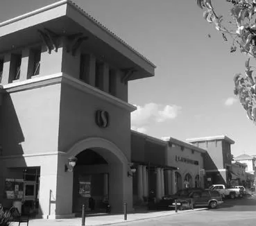 Storefront of grocery store connecting to neighboring apartment building.