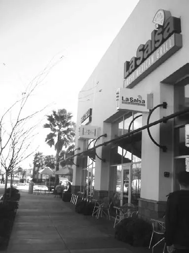 Desirable storefront signs in a multi-tenant commercial center.