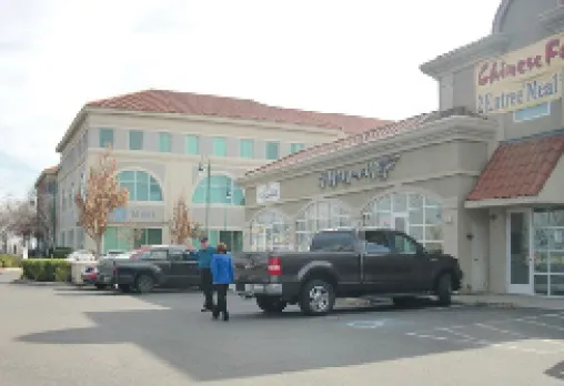 Small multi-tenant building within a commercial office center.