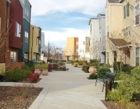 Large walkway used to breakup blocks of residential townhome buildings.