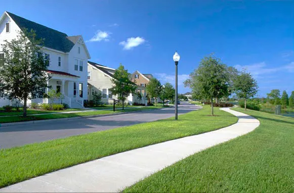 Wide separated sidewalk along a residential neighborhood.