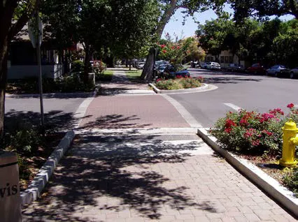 A cross walk with pavers in a residential neighborhood.