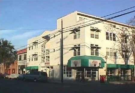 A three story vertical mixed use building.