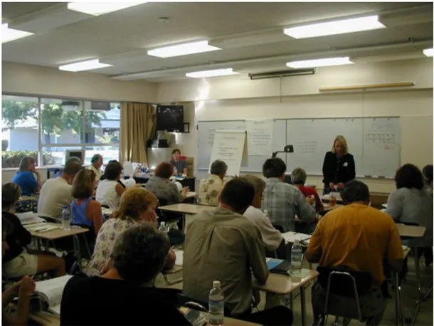 A community meeting being held in a classroom.