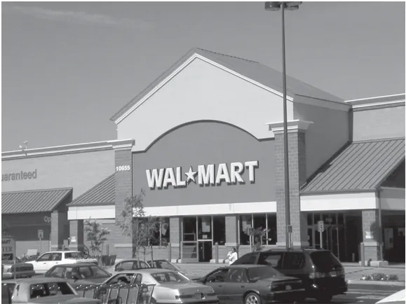 A Walmart building storefont viewed from the parking lot