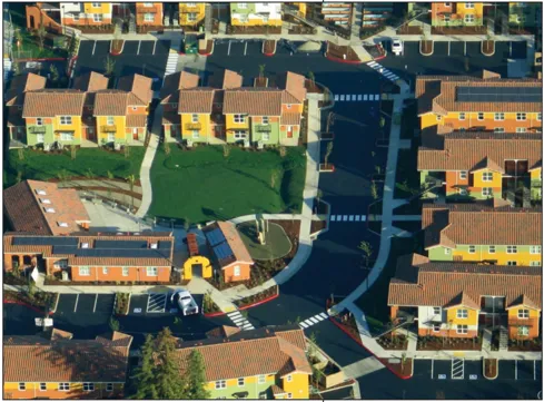 An aerial view of streets lined with multifamily buildings.