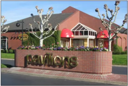 A monument sign adorned with flowers that says "Pavilions."