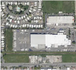 Aerial image of a truck parking business adjacent to a residential neighborhood.